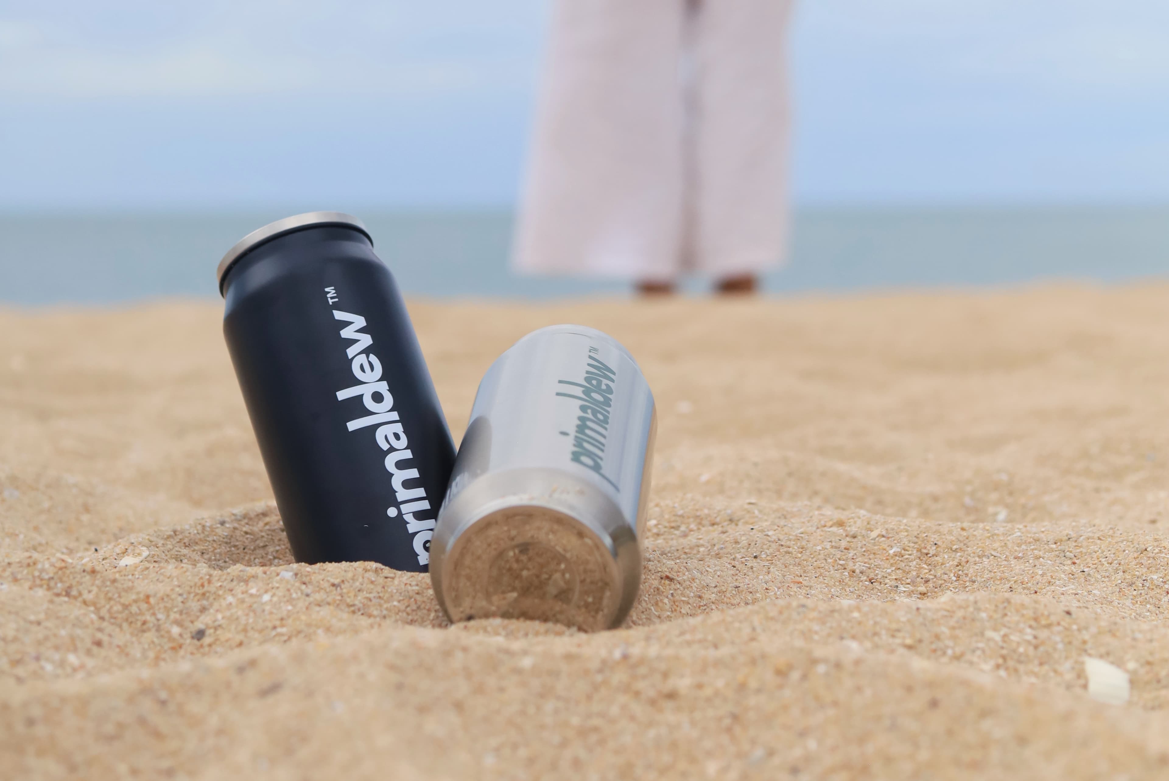 Primaldew tumblers on a Thai beach at sunset — daily super greens supplement for active lifestyles